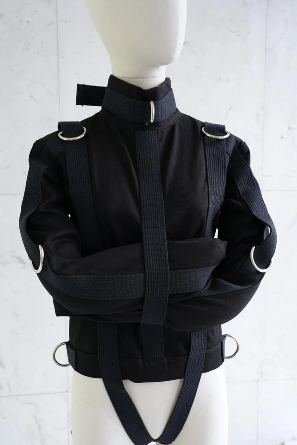 “Black theatrical straitjacket costume with side crotch straps and welded D-rings – canvas professional design by The Strait Jackets”